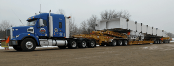 13-axle trailer parked in dirt lot